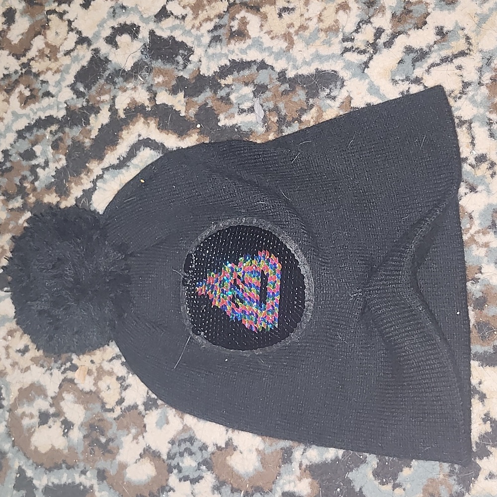 Rainbow poop emoji sequence black beanie hat.